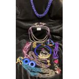 A selection of purple beaded costume jewellery.