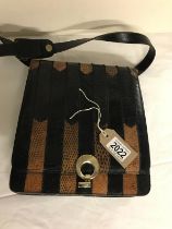 Vintage black and Tan snakeskin shoulder bag. Two interior segments, separated by zip pockets.