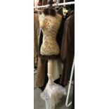 A Mannequin in an abstract jacquard bodice with feather trim