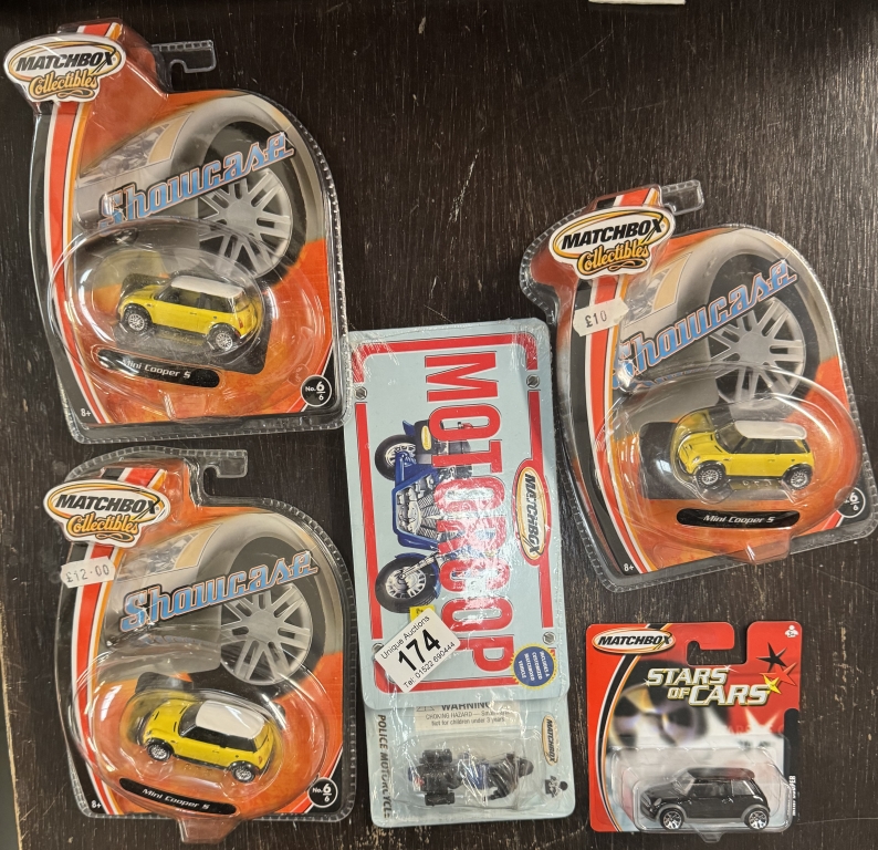 A quantity of Matchbox collectables showcase Mini's & A Motor cop police motorcycle with books