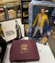 A Freddie Mercury 18'' figure, book & Queen video box set