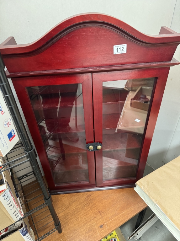 A dark wood stained collectors display cabinet. Height 86cm, Width 55cm, Depth 15cm