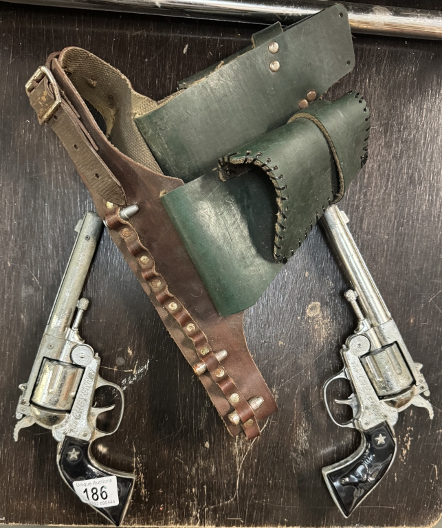 A pair of Vintage Lone Star Cheyenne Cowboy cap guns with holster belt