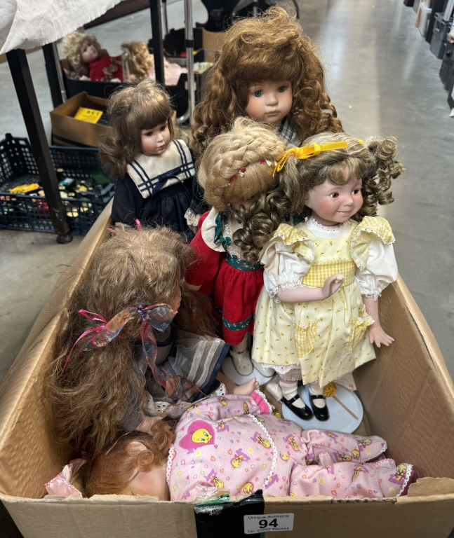 A quantity of porcelain dolls including sleeping baby