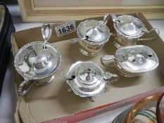 A quantity of silver plate salt and mustard pots.