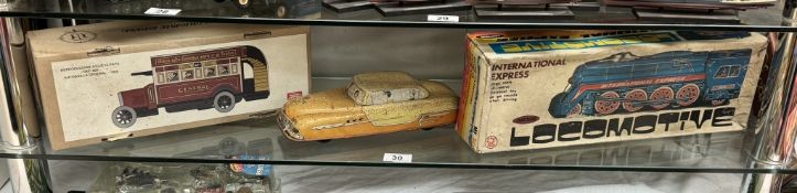 A boxed international express locomotive, Paya clockwork tinplate bus & A large Mettoy tin