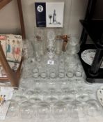 A quantity of Wine & brandy glasses, 2 decanters, boxed cheese cutters etc