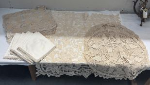 A lace tablecloth, 3 round lace tablecloths, 8 placemats, 8 matching serviettes