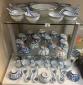A large quantity of Chinese blue & white soup bowls, spoons etc