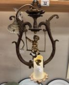 A cherub surmounted gilded metal ceiling light