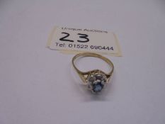 A diamond and blue stone set ring in 9ct gold, size O half, 1.55 grams.