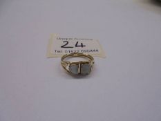 A 14ct gold ring set milk opals with openwork shoulders, size Q, 3.23 grams.