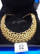 A cased yellow metal collar/choker by Kenneth Lane, USA.