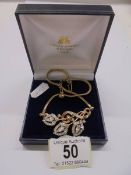 A superb quality floral spray stone set pendant in yellow metal.