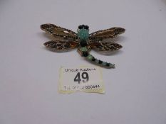 A large stone set dragonfly brooch/pendant in yellow metal.
