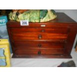 A small mahogany three drawer chest,.