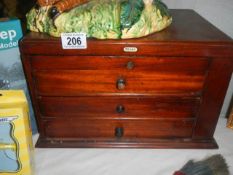 A small mahogany three drawer chest,.