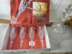 A glass decanter and a boxed set of four glasses.