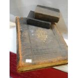 A large old Bible and two smaller examples.