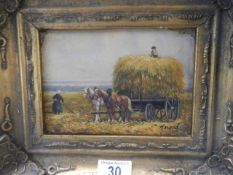 A gilt framed hay making scene.