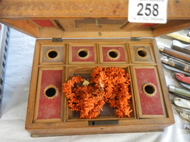 A carved jewellery box and contents.