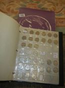 A boxed coin album and mixed coins.