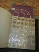 A boxed coin album and mixed coins.