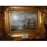 A gilt framed windmill scene.