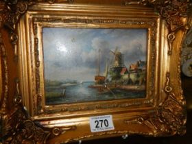 A gilt framed windmill scene.