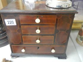 A mahogany inlaid work chest with lift up lid.