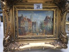 A gilt framed street scene,