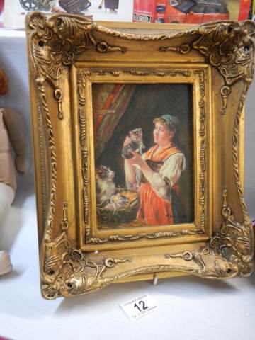 A gilt framed study of a lady with cat and kittens.