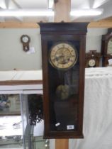 A mahogany wall clock, spring good and works but doesn't chime. COLLECT ONLY.