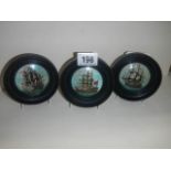 Three framed pot lids depicting tall ships.