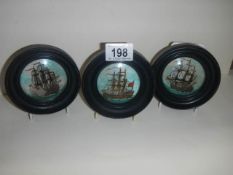 Three framed pot lids depicting tall ships.
