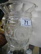 A glass celery vase with lions head decoration.