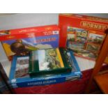 Four railway related jigsaw puzzles including two Hornby.