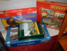 Four railway related jigsaw puzzles including two Hornby.