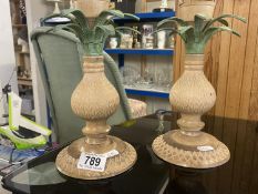A pair of painted brass candlesticks