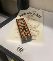 A boxed Hohner great little harp harmonica and an instruction book