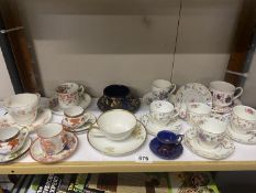 A German porcelain peaches cup and saucers and quantity of other cups and saucers including a trio