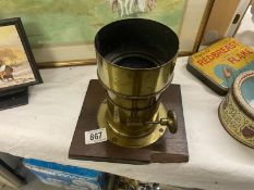A large brass camera/magic lantern lens