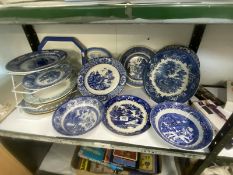 A shelf of early 20c onwards blue and white plates etc