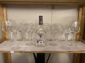 A set of 4 cocktail glasses and quantity of wine glasses plus a decorative (empty) whiskey bottle