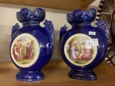A pair of Edwardian blue pottery vases with pot lid style classical decoration