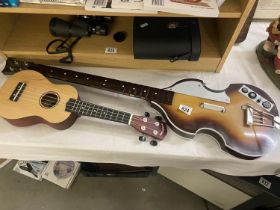 A rock band video game electric guitar controller and a ukele