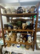 A large collection of mugs, tankards etc on 4 shelves