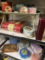 2 shelves of tins and boxes including a vintage portable tin tray