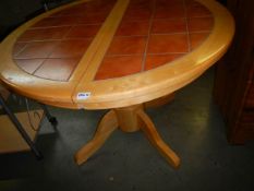 A good circular dining table with tiled top, COLLECT ONLY.