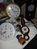 A mixed lot of clocks and barometers.